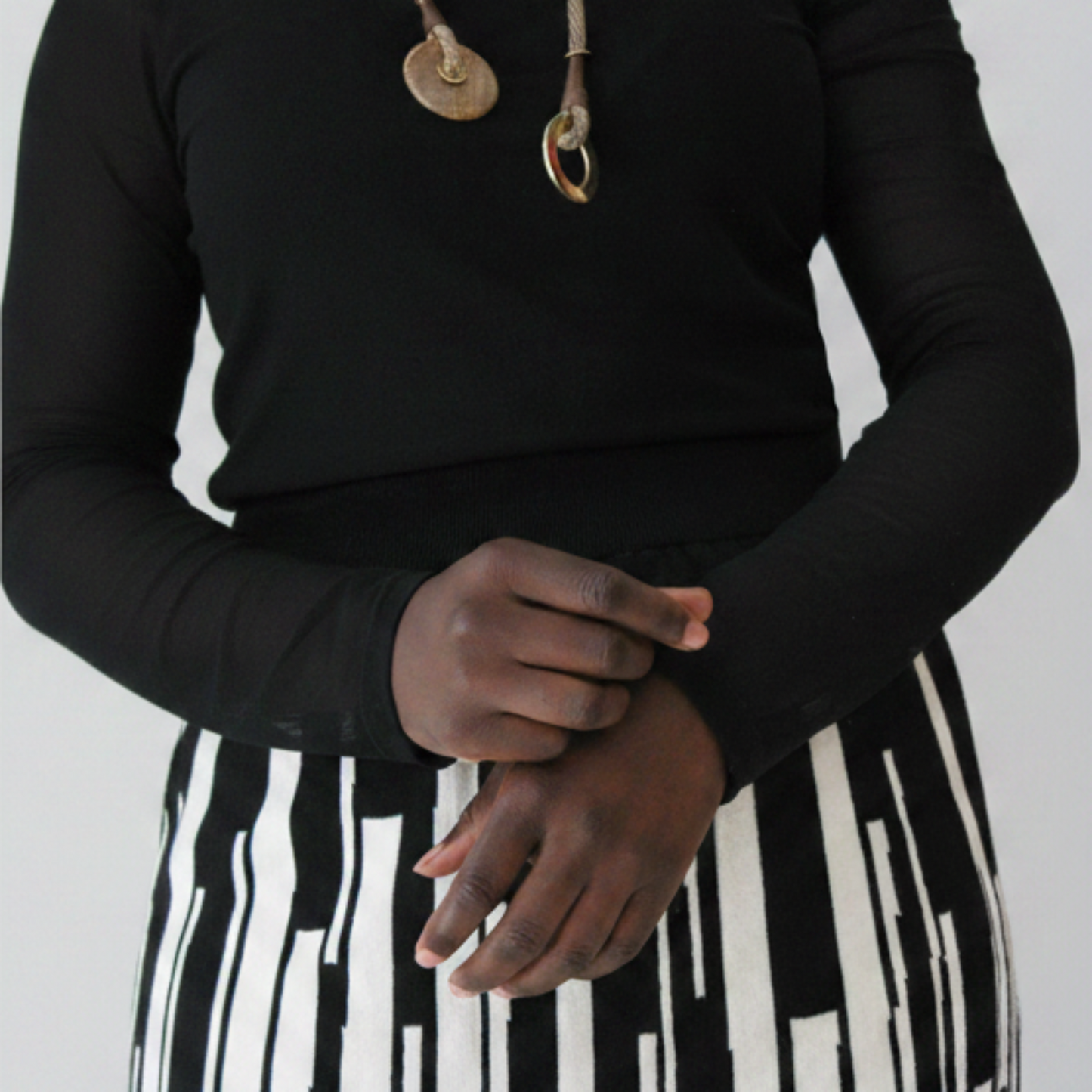 Close up of the mesh top sleeves and contrast black & white knitted skirt.