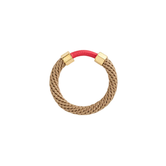 Bracelet with gold clasp and red band on a white background