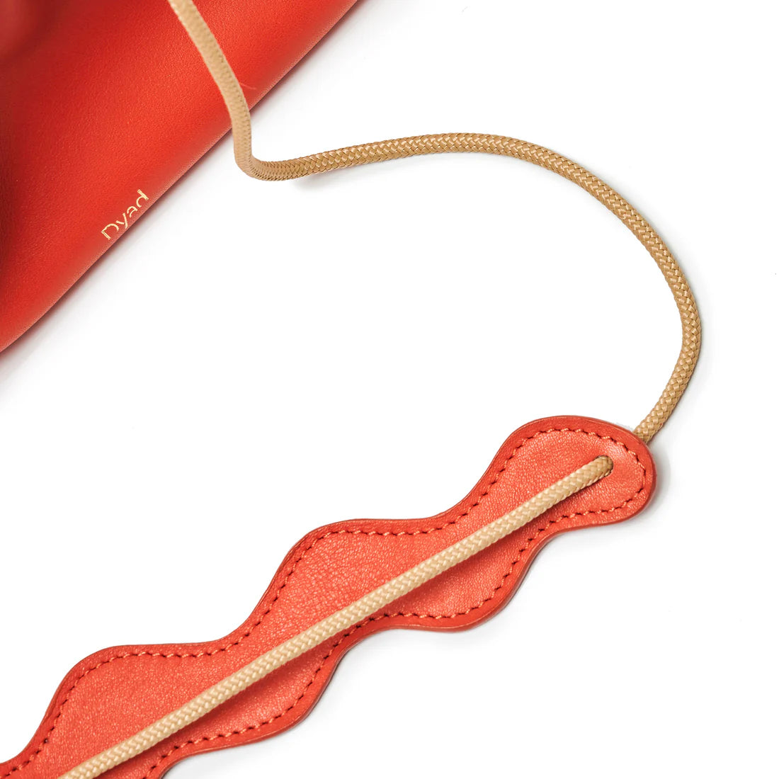 Red-Orange strap with beige cord on a white background