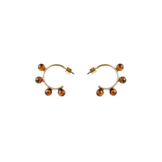 A pair of gold-colored hoop earrings with tiger eye beads placed on a white background.