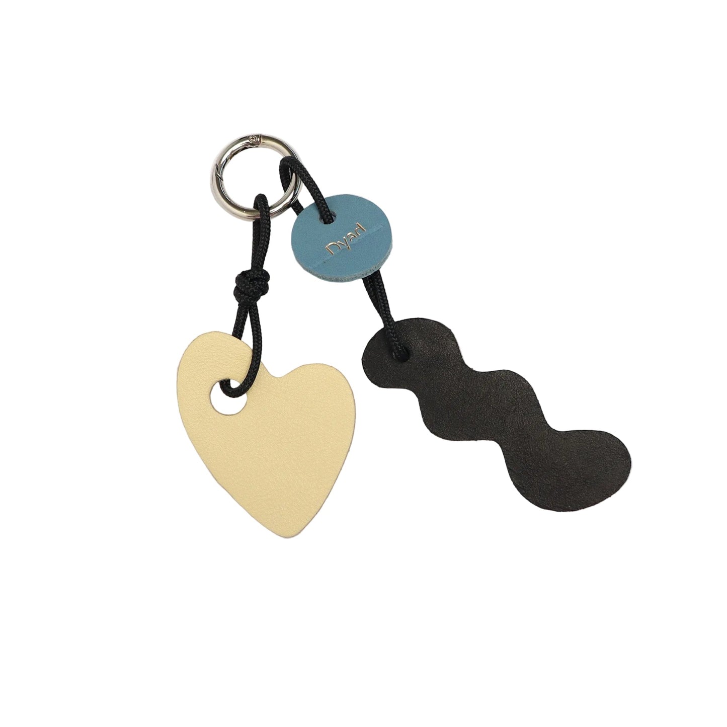 Keychain with heart-shaped and wavy black tag on a white background