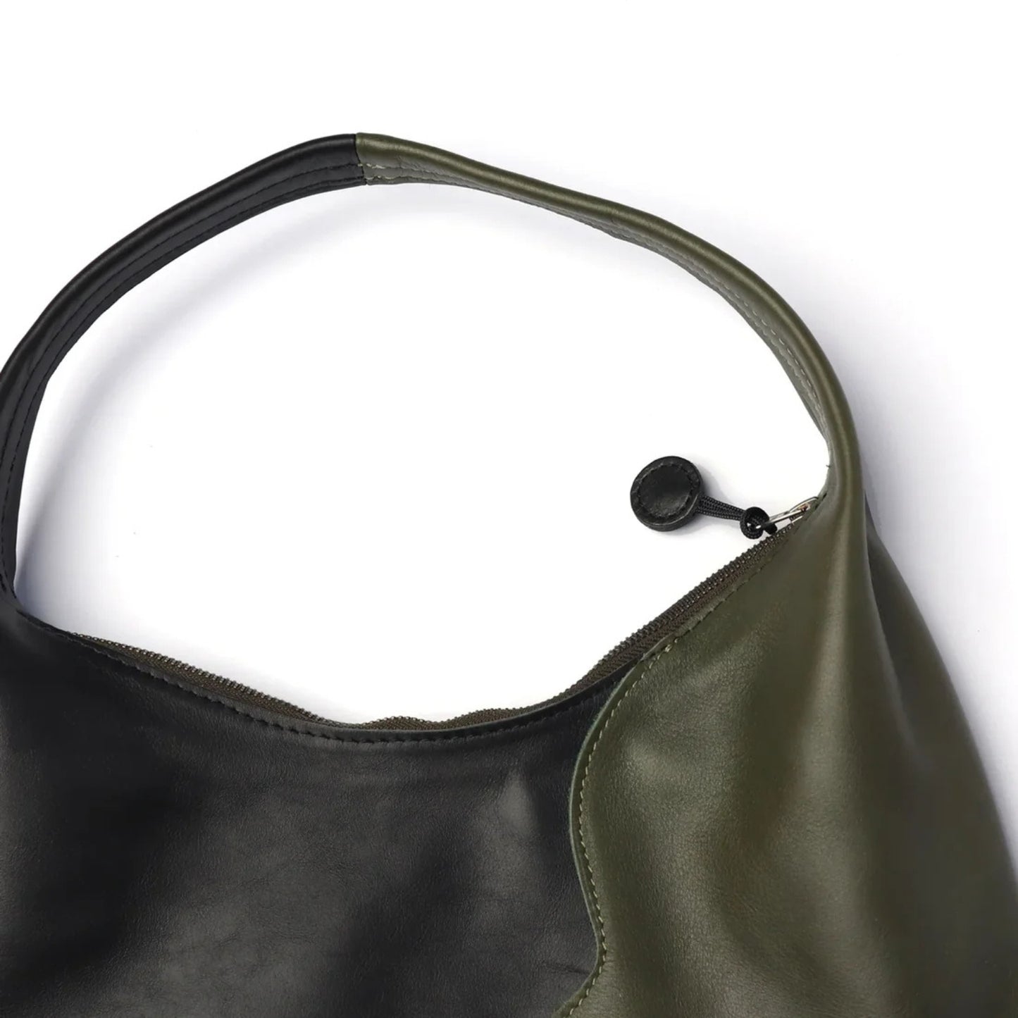 Close up mage of the Libra Moss Black handle and two tone zip.
