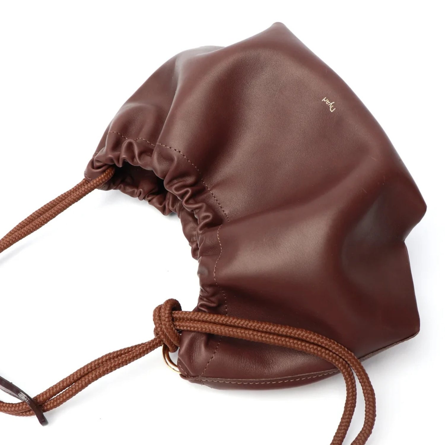 Brown leather drawstring gather style closure top bag on a white background