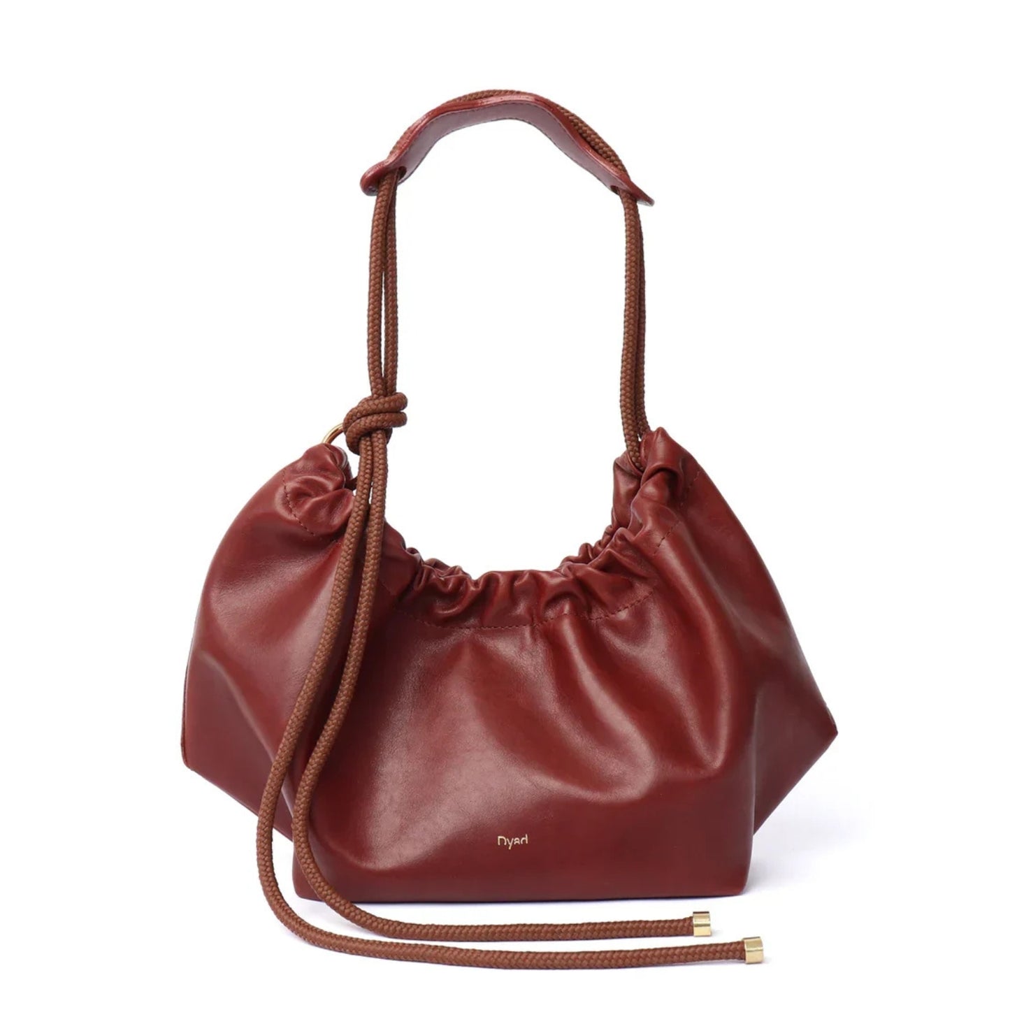 A mahogany brown leather slouchy shoulder bag with a ruche closure and a single top handle.