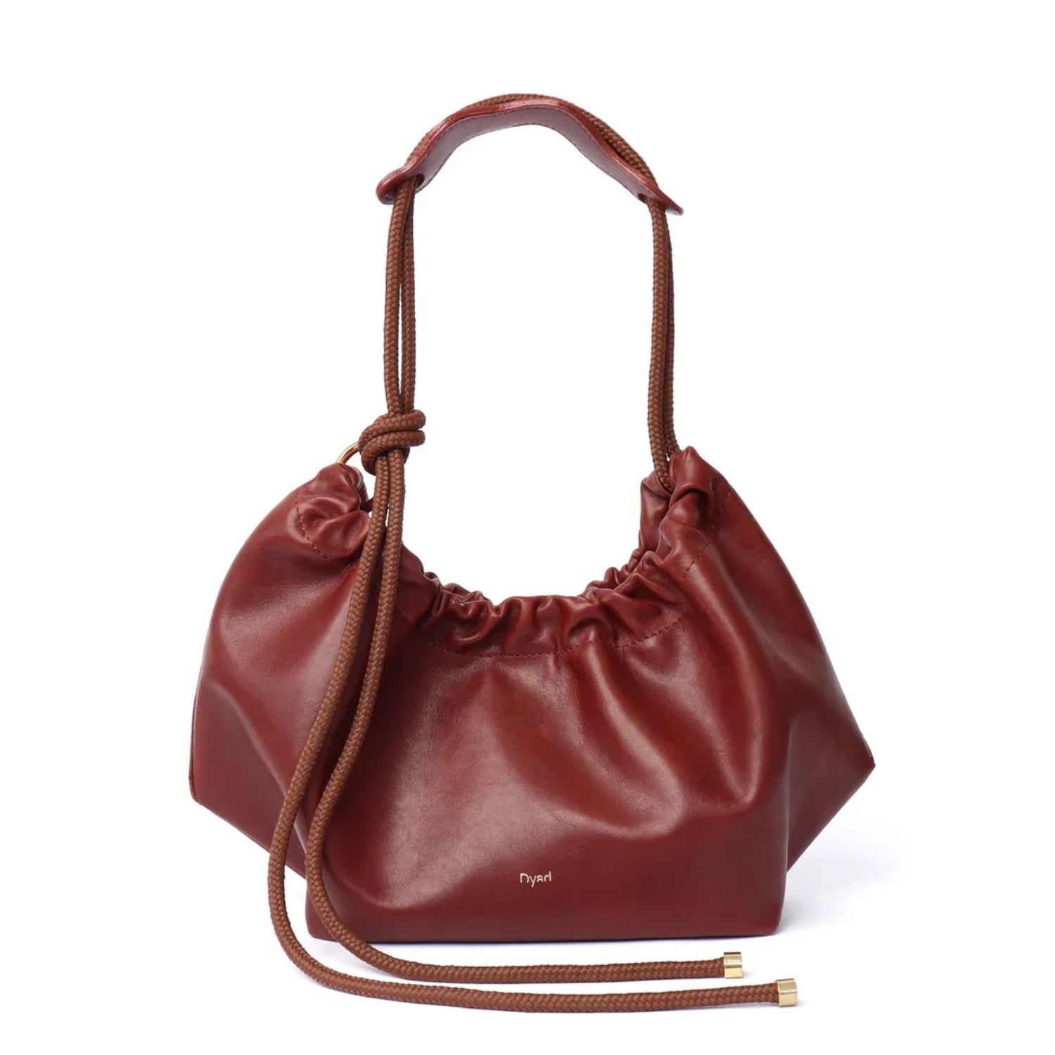 A mahogany brown leather slouchy shoulder bag with a ruche closure and a single top handle.