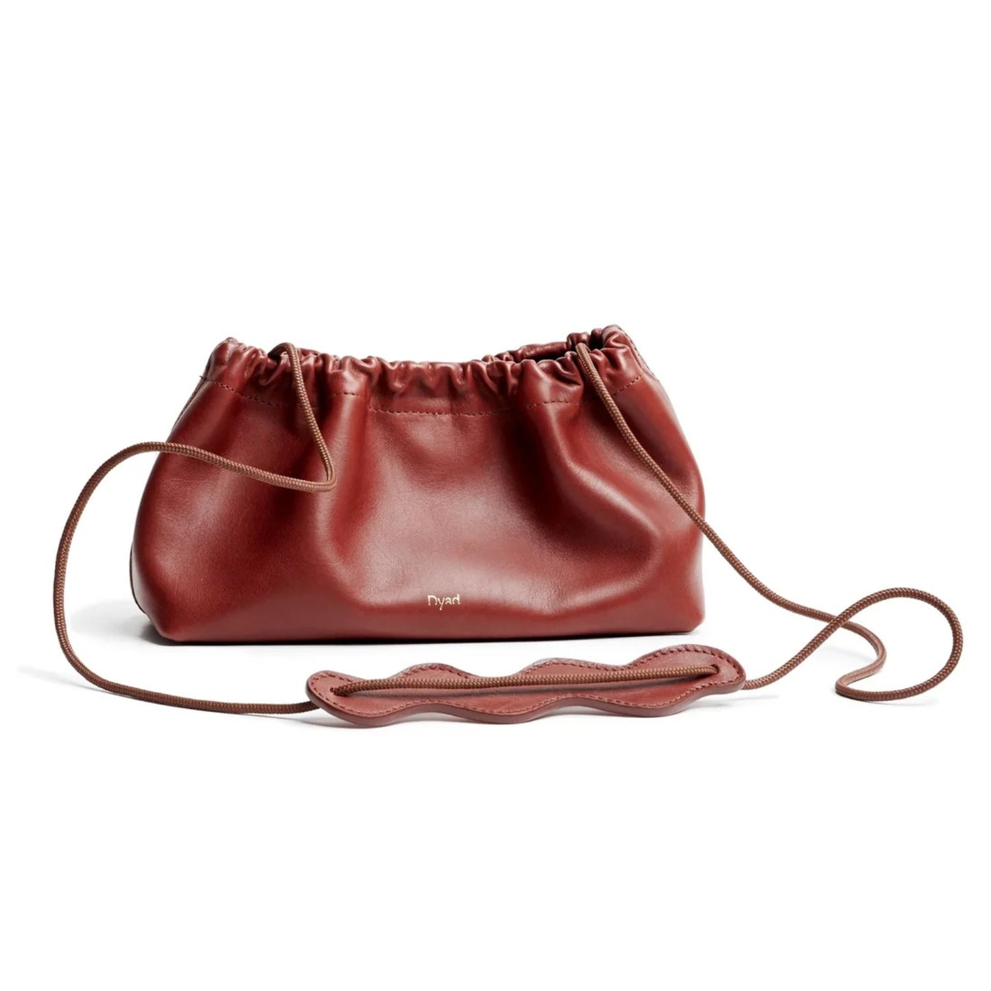 A reddish-brown leather, a ruche closure bag with a long matching shoulder strap