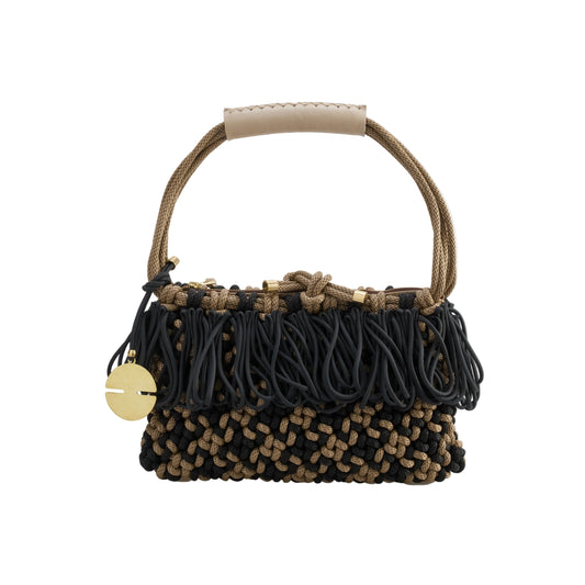 Handbag with braided design and black tassels on a white background