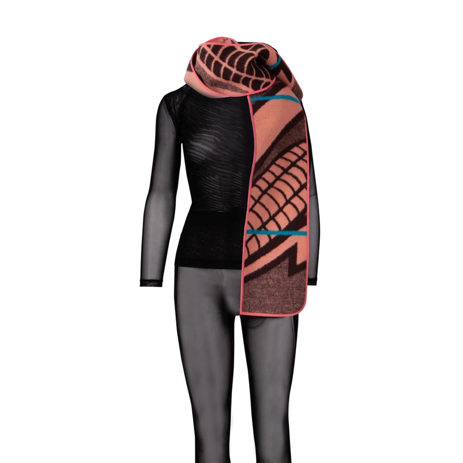 A patterned knit scarf draped over a black long-sleeve top and black tights on a mannequin, shown against a plain white background.