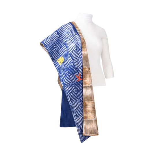 A blue patterned shawl draped over a white mannequin torso against a plain white background.