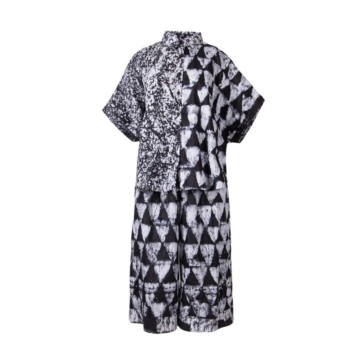 A short-sleeve, high-neck collar shirt-style top with a split design: one half features a black and white abstract print, and the other half features a black and white geometric triangle pattern, shown against a plain white background.