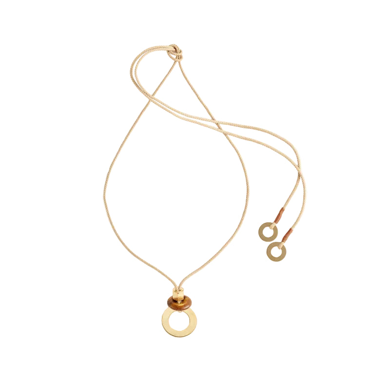 A gold-colored necklace with a brass and tigers eye pendant, displayed against a white background.