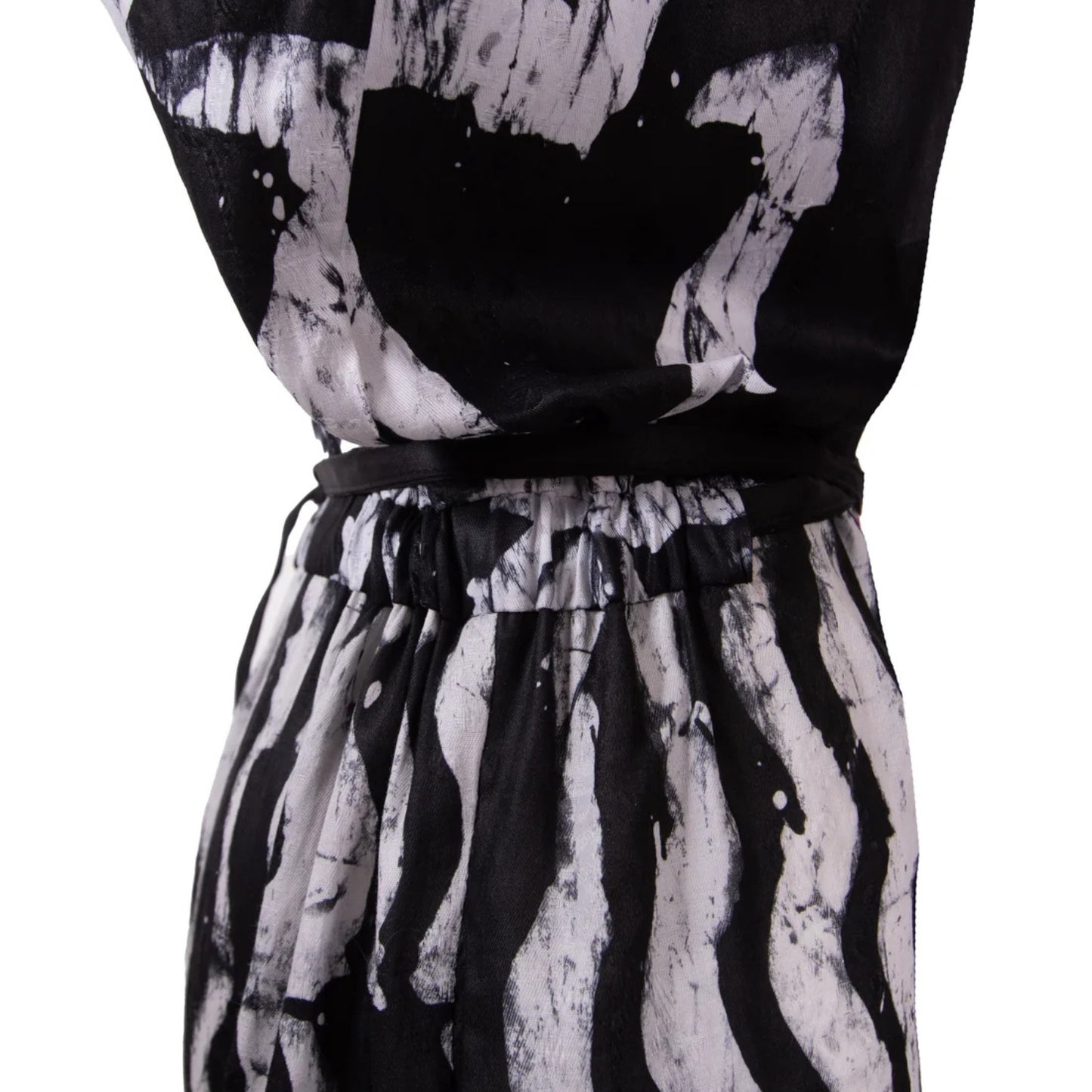 Black and white abstract print Jumpsuit with a matching black waist tie belt, shown on a white background.