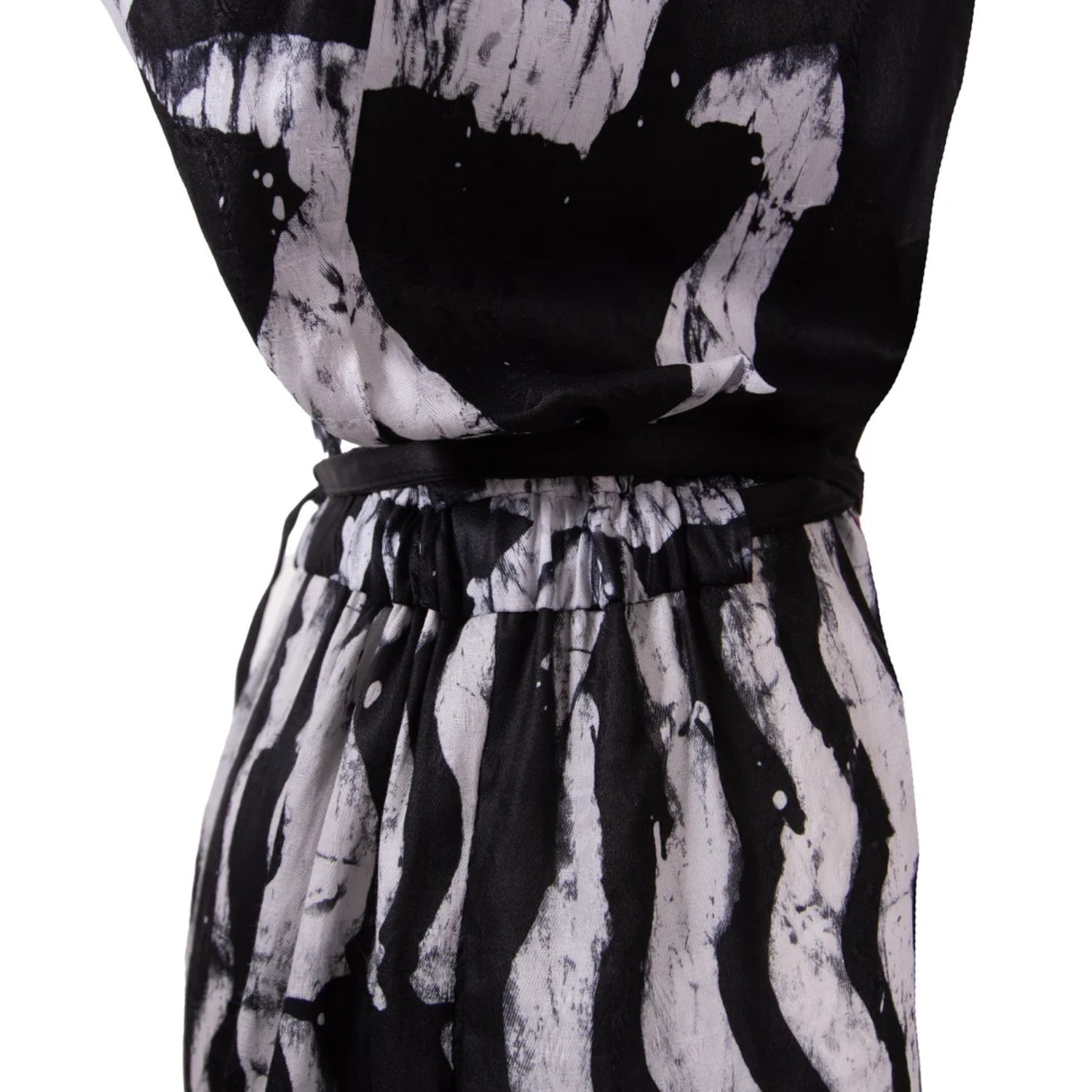 Black and white abstract print Jumpsuit with a matching black waist tie belt, shown on a white background.