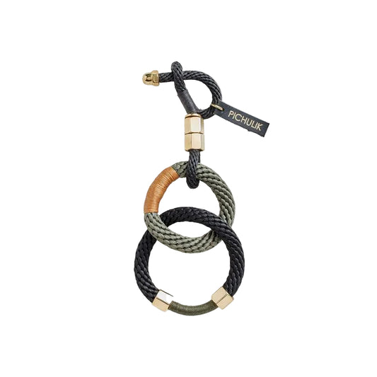 Bracelet with interlocking loops in black, brown, and green on a white background