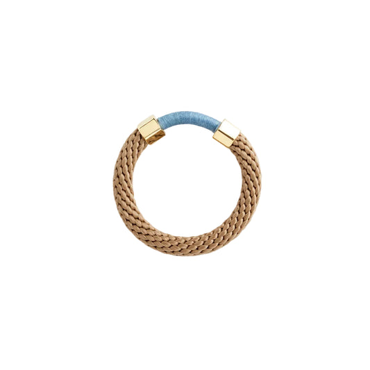 Bracelet with gold clasp and blue accent on a white background