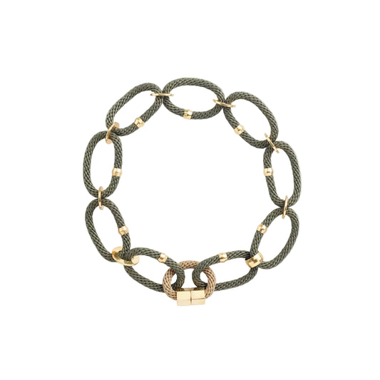 Woven necklace with gold and brass bead links on a light background