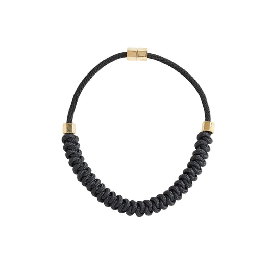 Black braided necklace with gold accents on a white background