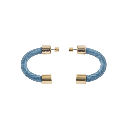 A pair of open cuff bracelets featuring textured light blue cord wrapped inside polished gold-tone metal tubes, displayed on a clean white background.