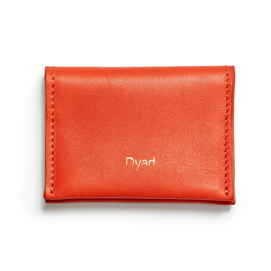 Orange leather wallet with 'Dyad' branding on background