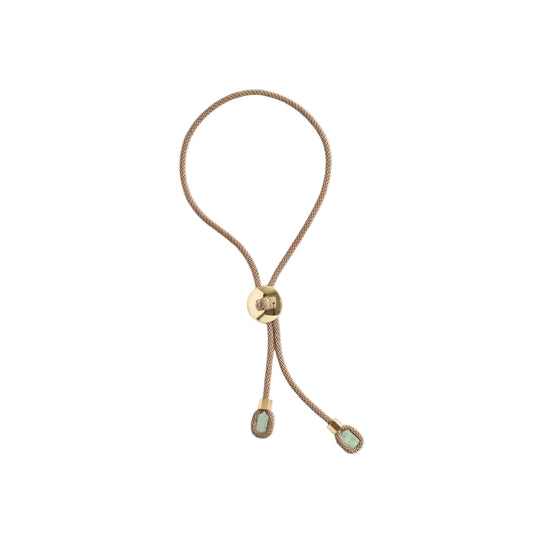 Pendant with gold clasp and green stones on a white background