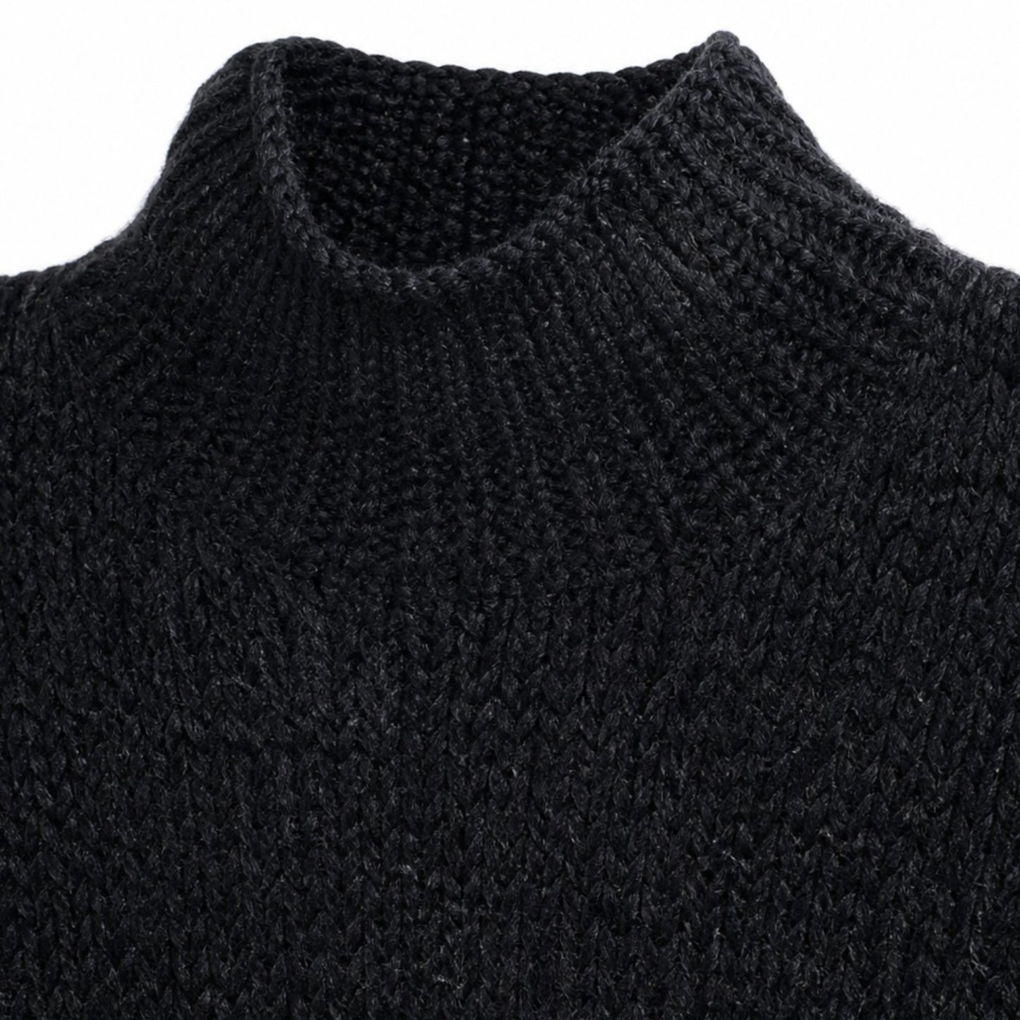 Close-up of a black knitted sweater with a high collar on a white background