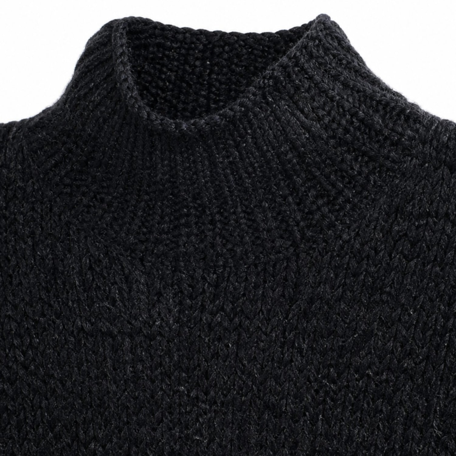 Close-up of a black knitted sweater with a high collar on a white background