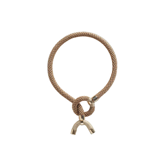 Brass-colored rope necklace with a unique clasp on a white background