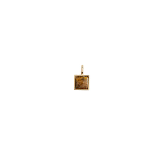 Gold pendant with a small square inset on a white background