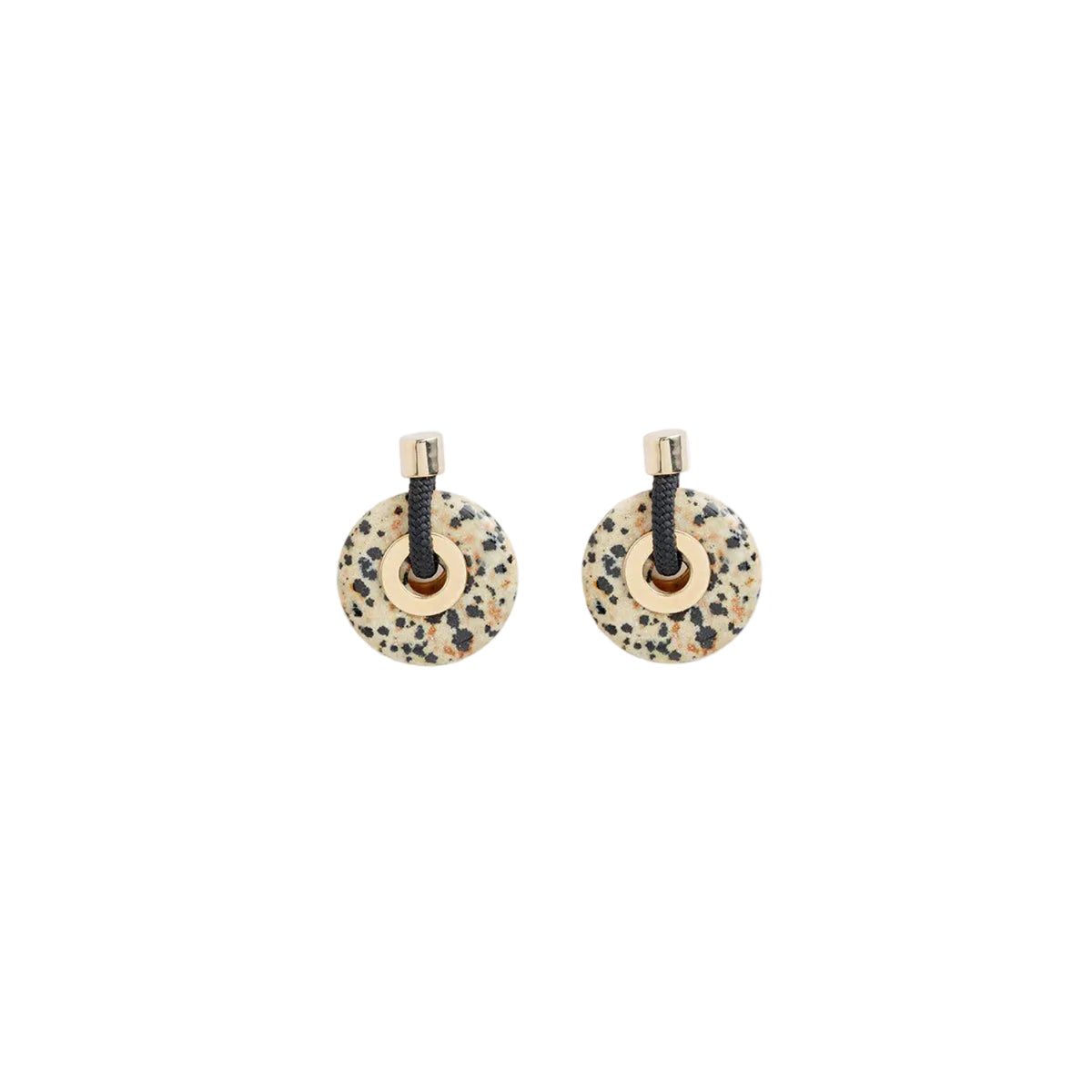 A pair of round disc earrings with a speckled beige and black stone-like pattern, connected by a black cord and finished with gold-toned metal caps, shown on a plain white background.