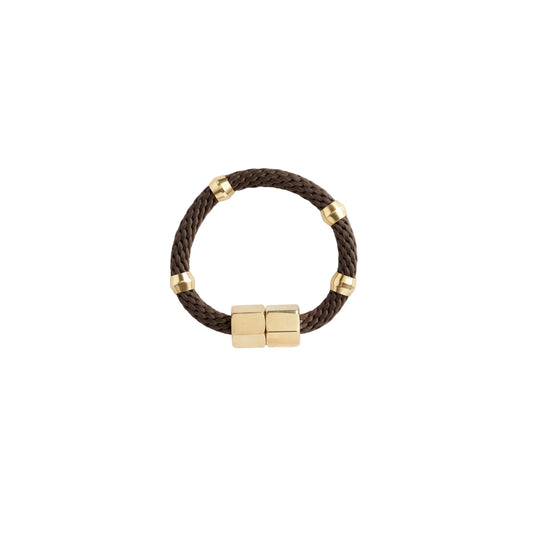A brown bracelet with brass rings and a magnetic brass clasp on a white background.