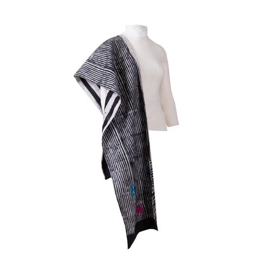 A black and white striped Damask woven wrap or shawl draped over a white mannequin torso against a plain white background.