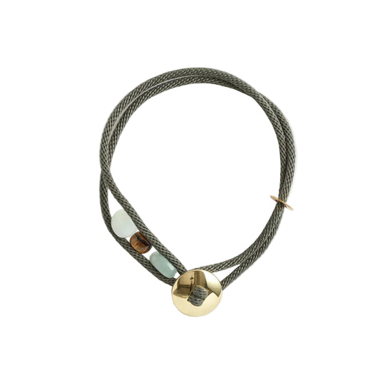 Olive green braided necklace with gold accents on a white background