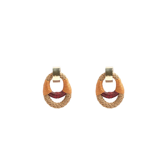 Pair of woven hoop earrings with gold accents on a white background