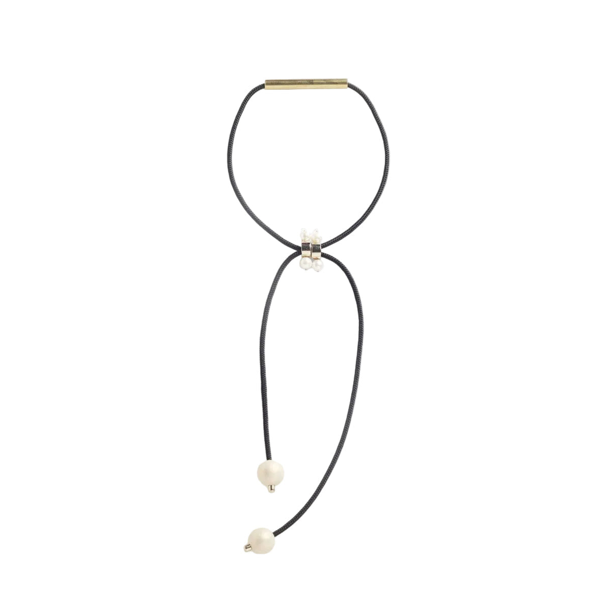 A black cord necklace with a gold bar clasp, a small white floral accent, and two dangling cream-colored beads, shown on a plain white background.