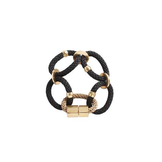 A black and gold bracelet with thin rope and brass end clasps, designed by PICHULIK.