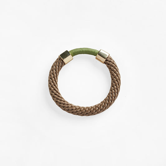 The Aruba Bracelet is a chunkier statement bracelet that features two metal embellishments. The rope texture and contrasting colours in the bracelet offers a unique look.