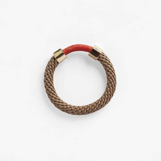 The Aruba Bracelet is a chunkier statement bracelet that features two metal embellishments. The rope texture and contrasting colours in the bracelet offers a unique look.